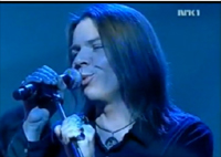 Norwegian Rock Star Henrik Johnsen from Pluto and the Planets wearing his black diode amulet on NRK-TV performance
