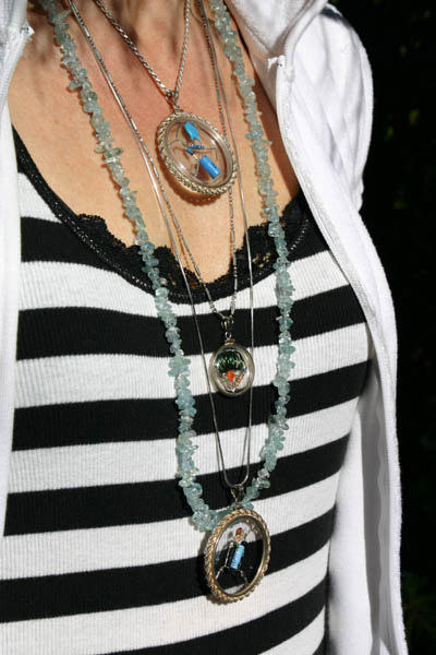 woman's torso showing an array of amulets