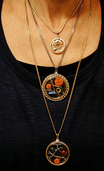 woman's torso showing an array of amulets