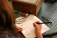 Xochitl Flores writing in her logbook